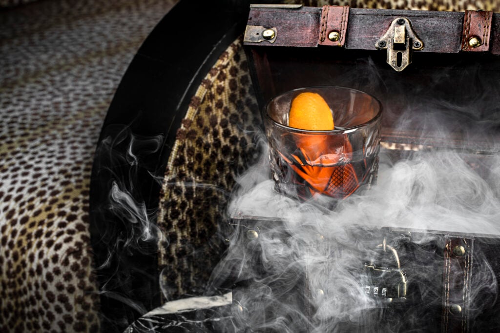 a glass with an orange in it