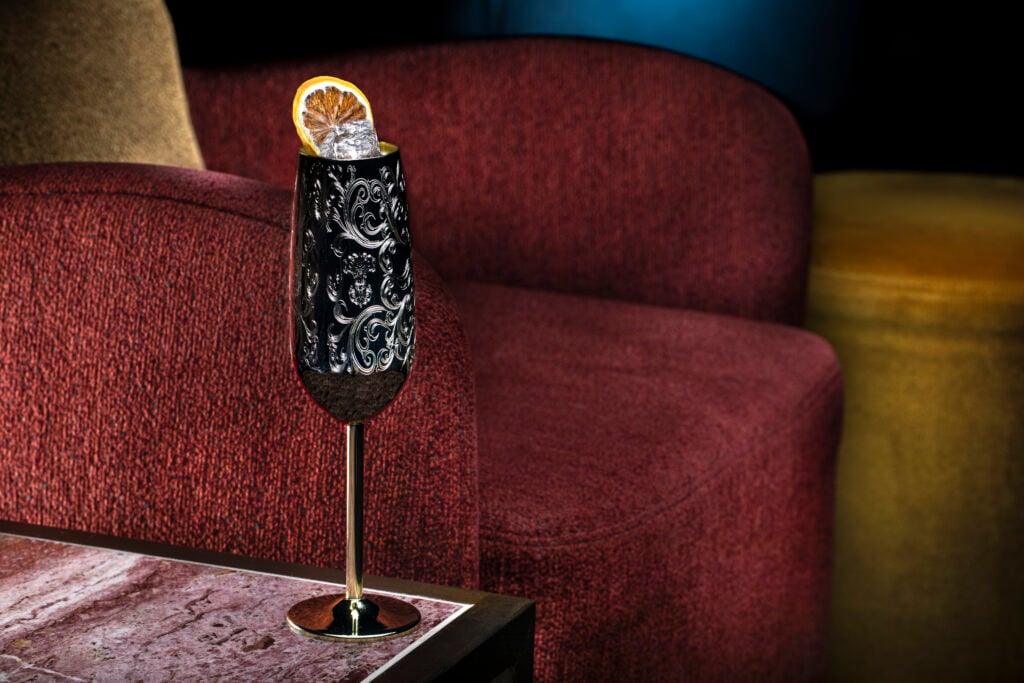 a glass with a slice of orange on it