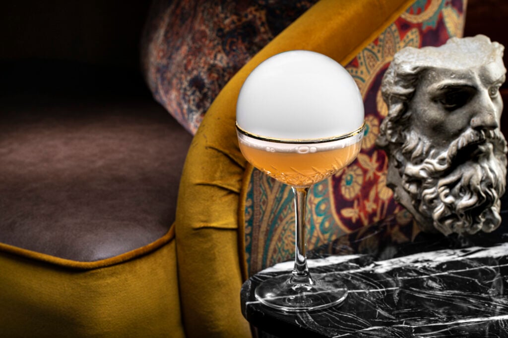 a glass with a white and yellow liquid in it