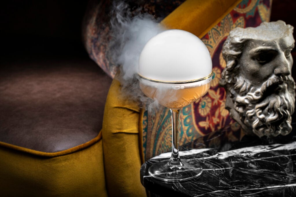 a glass with a white sphere in it