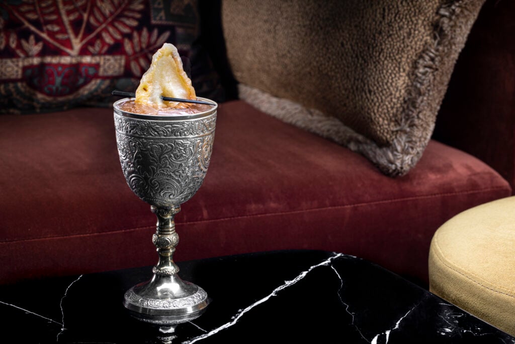 a silver cup with a piece of food on it