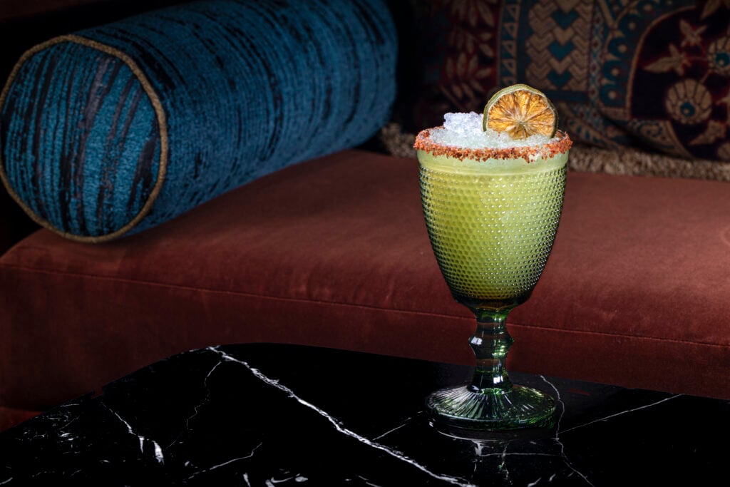 a glass with a drink on a table