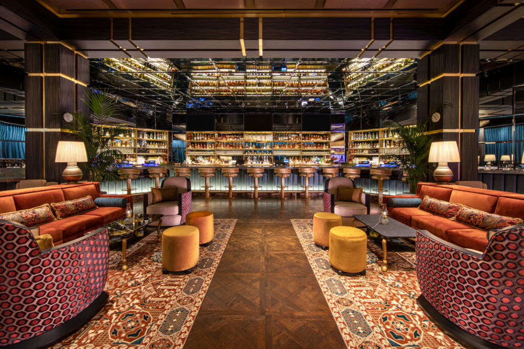 a room with a bar and shelves of liquor