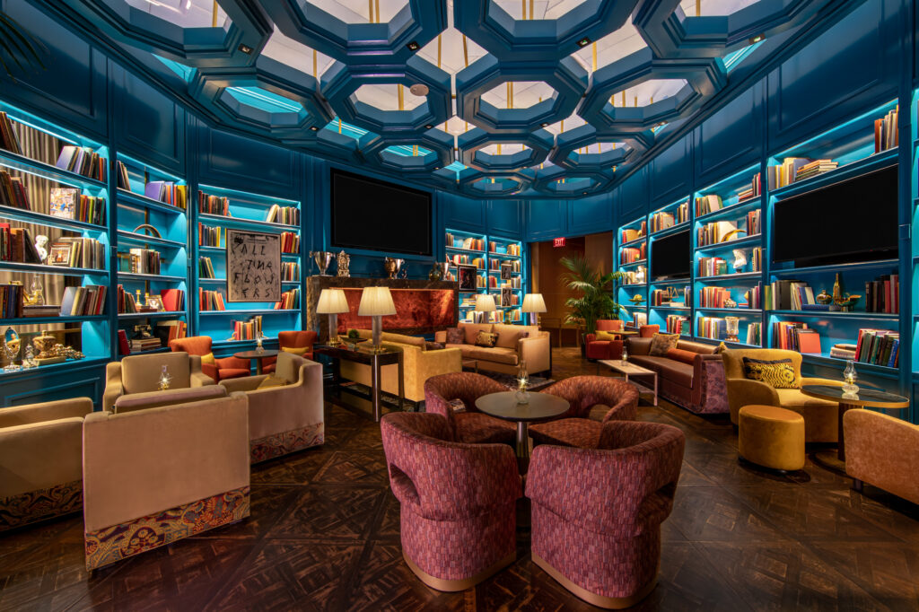 a room with a large ceiling and a table with chairs and a tv