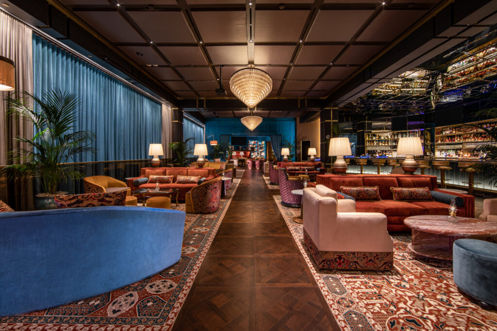 a room with a large area with couches and tables