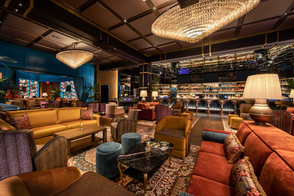 a room with a large chandelier and couches